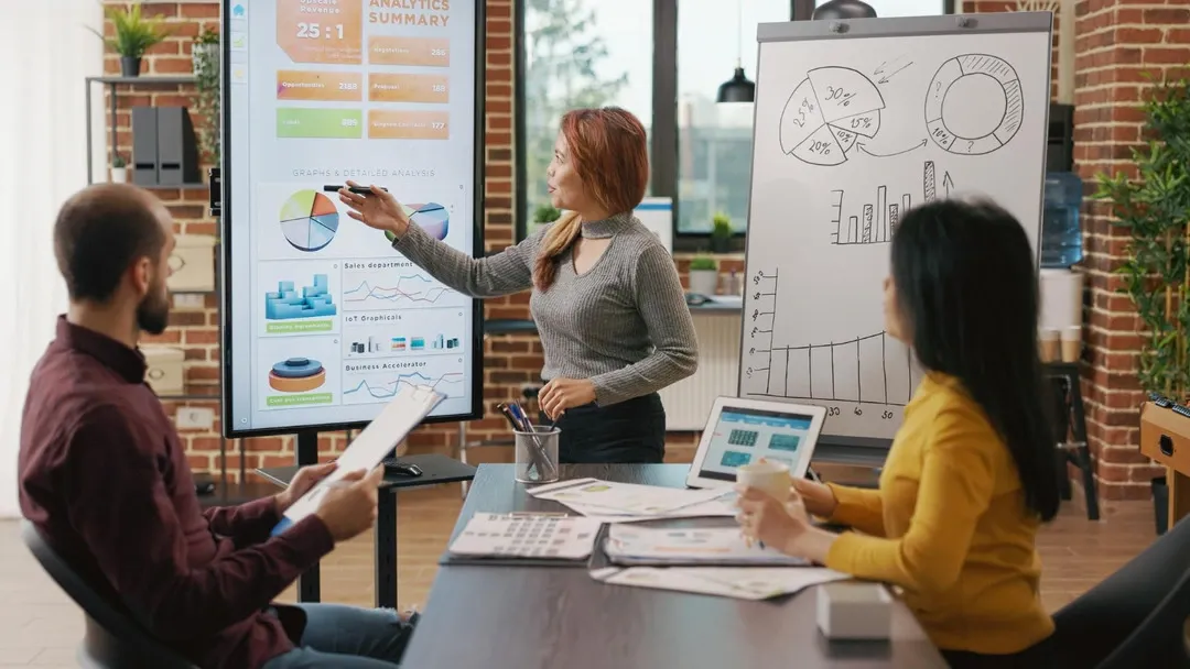 Business professionals reviewing marketing analytics and diverse strategies on a digital screen