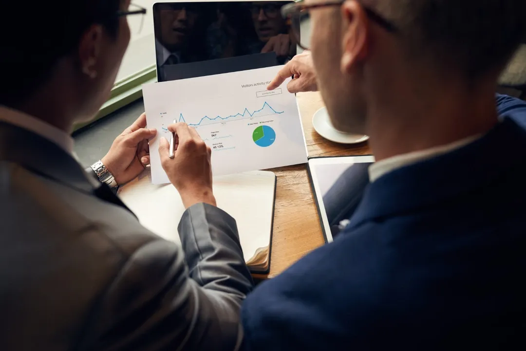 Printed report with graphs and charts being evaluated for market competition insights