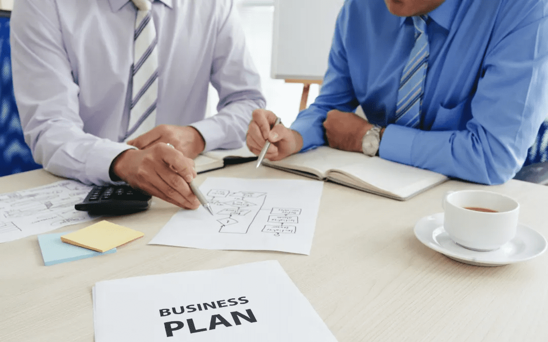 Business meeting focusing on drafting and analyzing a business plan