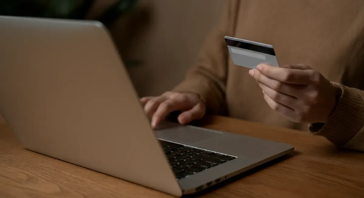 Person booking paddleboard rental online with a card