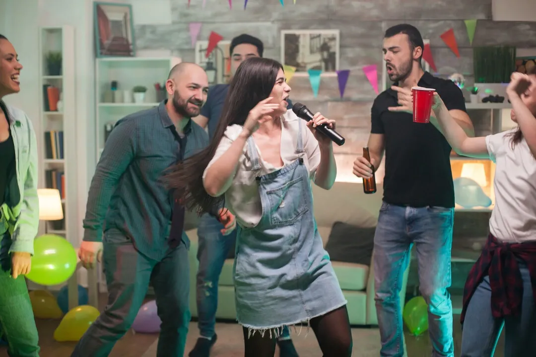 Group singing karaoke at a lively party