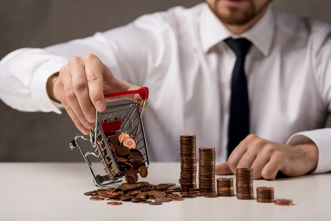 Person pouring coins from a cart onto a table, symbolizing funding ideas for car rentals